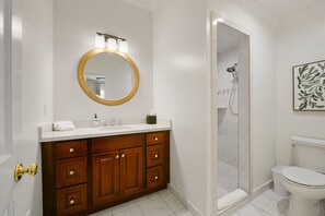 Renovated bathroom with a modern shower and thoughtful amenities