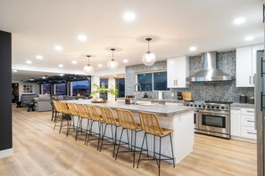 Open concept kitchen with a large island and plenty of seating to gather around.