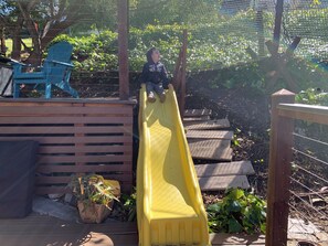 Having fun coming down the slide.