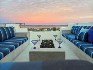 Snuggle up on the rooftop with comfy seating, breathtaking views, and a fire table for cooler nights (2)