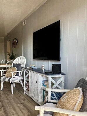 55” smart TV and cabinet full of beach reads and fun games