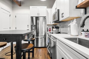 Fully equipped kitchen with bar and stainless appliances