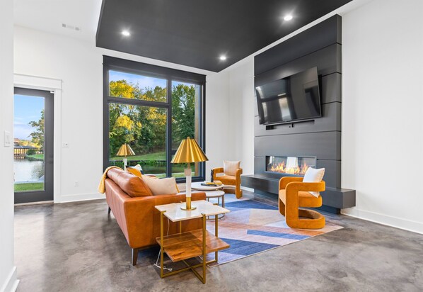 Bright and spacious, this living area features large windows, stylish decor, and a layout that encourages relaxation and conversation.