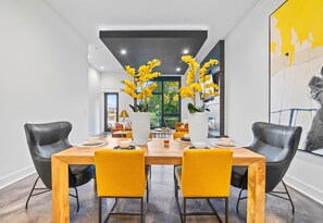 A closer look at the dining area, where sleek furniture and colorful touches create a warm and welcoming atmosphere.