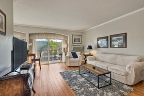 Spacious living room features a queen sized sofa bed