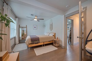 Second bedroom with view of lush yard