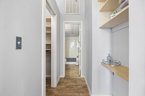 Walk in closet to your left with shelves to the right for added storage