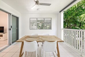 Step outside onto the peaceful balcony surrounded by greenery and a serene ambience.