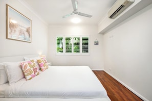 Wake up to peaceful views of lush greenery through the primary bedroom windows.