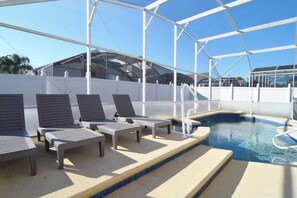 Gorgeous private west-facing pool deck with lounger area, shaded dining area