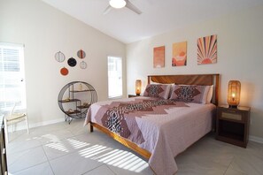 King room with en suite, walk-in closet, fan, Smart TV, doors to the pool deck