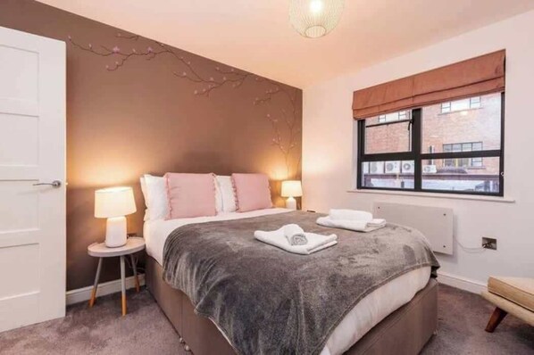 Soft ambient lighting, a luxurious king-sized bed adorned with high-thread-count linens, and bespoke furnishings create a sense of indulgence.