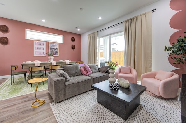 Cozy living room with plush couch and dining area behind