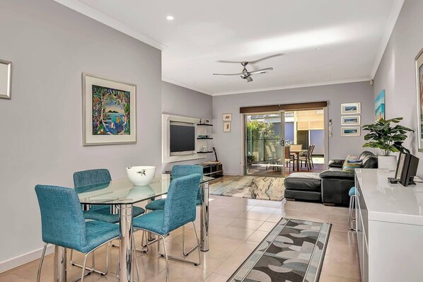 Another view of the dining area, located next to the downstairs living room. Overlooking the backyard, it provides a cool retreat on hot Adelaide days, letting you enjoy meals in comfort while still admiring the beauty of nature.