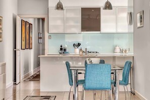 Positioned next to the kitchen island, the full dining set invites shared moments and meaningful conversations as you cook and dine in a warm, lively atmosphere.