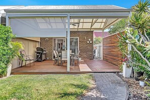 Relax in your own private alfresco dining area with a BBQ grill, perfect for a relaxed outdoor meal with friends and family. The spacious patio creates an ideal setting for warm evenings and memorable gatherings.