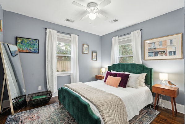 Bedroom #1 with queen-sized bed, smart TV, & small closet for clothing storage