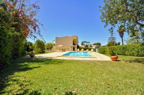 Villa side view of pool and garden