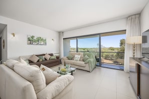 Living room area with patio doors and balcony