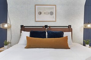 Spacious bedroom featuring a king bed, walk-in closet, and an en-suite bathroom with a relaxing shower/tub combo