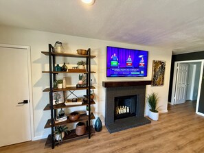Board games located in living room on bottom shelf. 