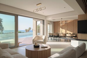 The living room features a lush corner sofa that comfortably accommodates the whole group, a 65” Smart TV, and a PlayStation 5 for ultimate entertainment