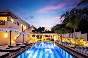 Soft lighting sets the scene for cozy poolside moments.
