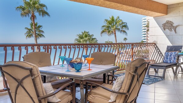The balcony with its dining table and chaise lounge chair.
