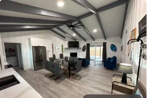 The living room offers plush seating, a Smart TV, and a cozy vibe 