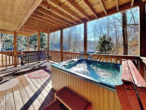 Deck Access off Game Room featuring a Hot Tub + Swing