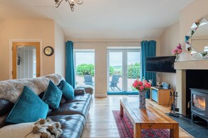 Open plan living room. With wood burning fire and views over the countryside. 