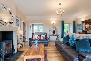 Open plan living room with wood burning fire.