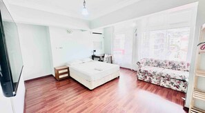 bed, sofa, TV, desk air conditioning , and a balcony for a cozy stay.
