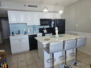 Newly remodeled kitchen with quartz countertops and sea glass back splash!