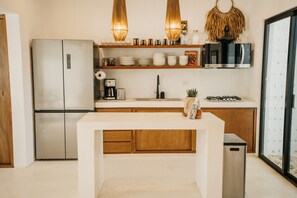 Kitchen with serving ware for 12, chilled purified water dispenser, coffee maker, blender, and toaster.