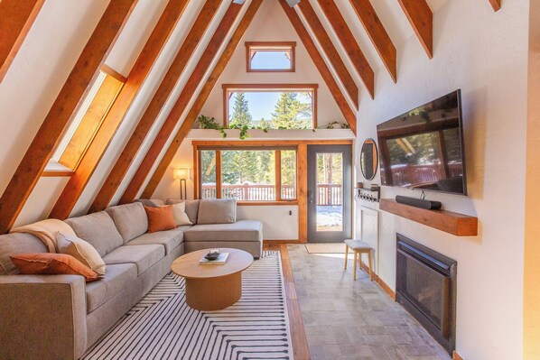 Living room with an abundance of natural light and views of the deck. 