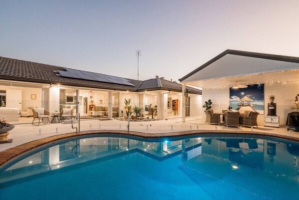 The stunning pool area is a true outdoor oasis, offering an expansive, open space perfect for relaxation and entertainment. The beautifully designed patio is adorned with high-quality outdoor furniture, making it ideal for lounging and socializing.