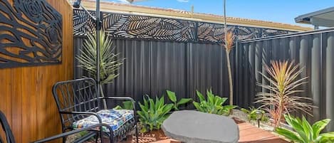 Enjoy the fresh air in this cozy outdoor sitting area