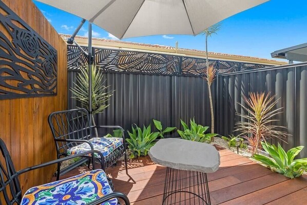 Enjoy the fresh air in this cozy outdoor sitting area