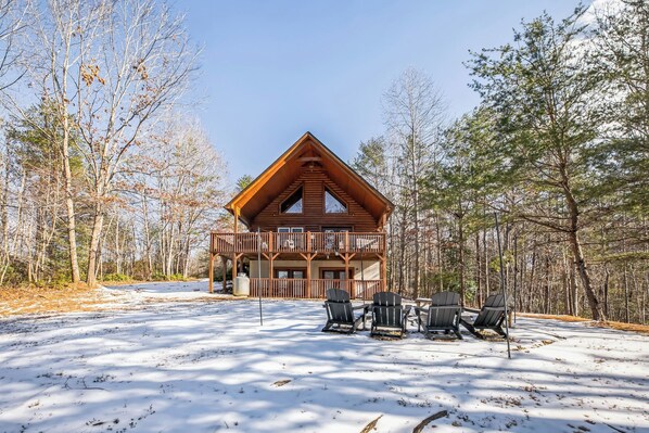 Enjoy time outdoors in this spacious yard equipped with a fire pit and adirondack chairs.