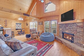 Spacious living room open to the dining space and kitchen. Enjoy the warmth of the gas log fireplace during the cold months.