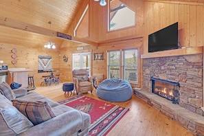 Spacious living room open to the dining space and kitchen. Enjoy the warmth of the gas log fireplace during the cold months.
