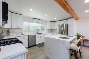 This sleek kitchen has clean lines, great lighting, and a modern design.