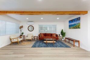 This bright, modern living room features recessed lighting and large windows.