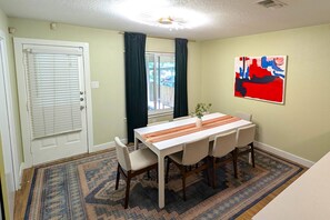 Dining room with seating for 8 plus 3 additional barstools by kitchen counter