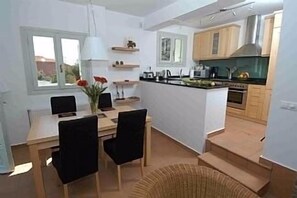 The very well equipped kitchen with adjacent dining area.