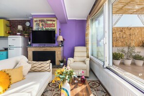 Relax in comfort with a cozy couch and TV for the perfect movie night!