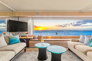 Spacious living area with ocean views and vibrant decor.