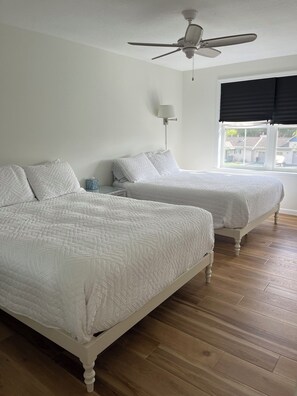 Northeast bedroom with two queen beds, spacious closet and slight views of lake.