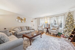Living room offering comfy furniture, games and a cozy fireplace
